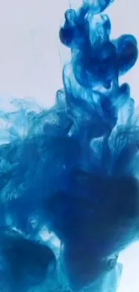 This stunning phone live wallpaper features a close-up shot of a vibrant blue substance swirling in water
