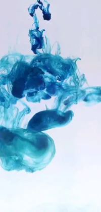 This live wallpaper features a stunning close-up of blue ink-like substance in water