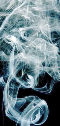 This live phone wallpaper features a mesmerizing close-up of spiraling white smoke on a black background