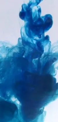 This phone live wallpaper is a stunning depiction of a blue substance being dissolved in water