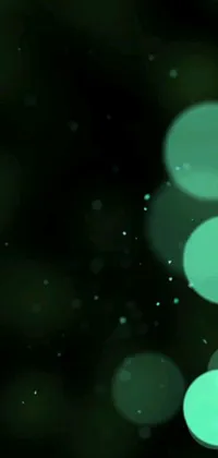 This phone live wallpaper features a mesmerizing digital artwork of blurry lights in shades of green against a black background, sourced from DeviantArt