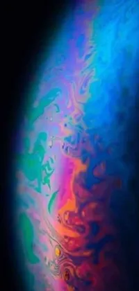 This stunning live wallpaper features a close-up of a cell phone on a black background with rainbow-colored liquids seeping out