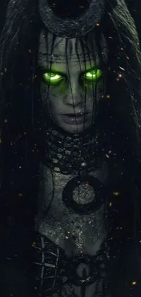 This phone live wallpaper features Gothic-inspired VFX art of a woman with long black hair and green eyes dressed in Shaman clothes