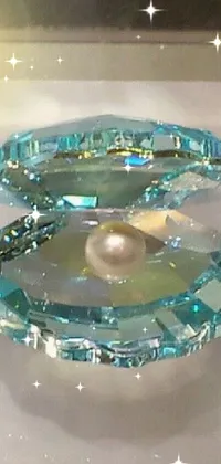 This phone live wallpaper showcases a crystal cubism artwork of a pearl within a glass object, adorned with shades of aquamarine
