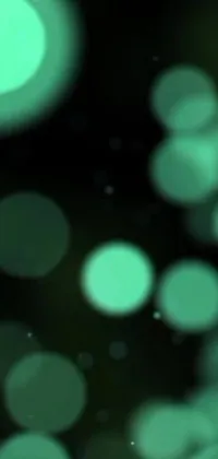 This stunning live wallpaper showcases blurry lights on a black background with a green and black color scheme, undersea bubble background, and low-quality grainy texture