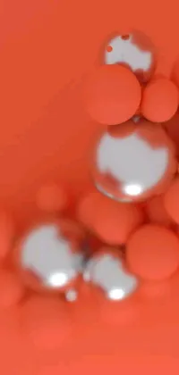 This phone live wallpaper showcases a digital art display featuring a cluster of orange balls sitting on a table