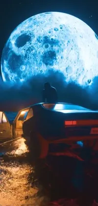 This phone live wallpaper is a stunningly moody and surreal image of a man sitting atop a vintage car in front of a full moon