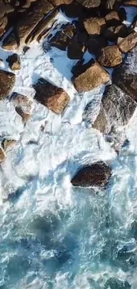 Enjoy the beauty of nature with this awe-inspiring phone live wallpaper of a rocky shoreline and foamy waves