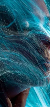 This live wallpaper boasts a stunning digital illustration of a person with blue hair and energy particles floating in the air around them