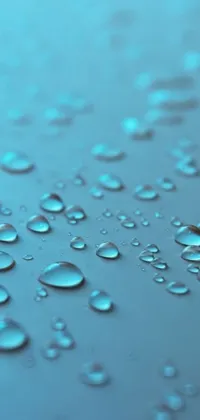 If you're looking for a stunning live wallpaper for your phone, this water droplet design is sure to impress! With a light blue background and blue bioluminescent plastics, this hyperdetailed image features droplets of water on a wet surface, complete with reflections of small objects and sparkles of light