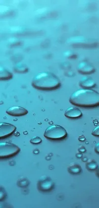 This captivating phone live wallpaper features a realistic 3D render of water droplets on a surface, in shades of blue and teal