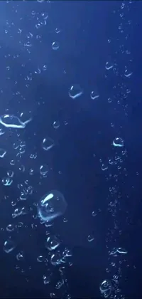 This live wallpaper features iridescent bubbles floating on a blue ocean surface, creating a tranquil and meditative ambient scene