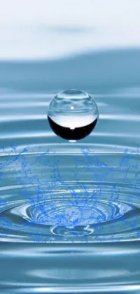 Experience the calming and mesmerizing effect of a stunning digital rendition of a water droplet falling into a calm body of water with this phone live wallpaper