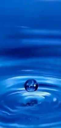 If you're looking for a remarkable live wallpaper that will add a touch of magic to your phone screen, this is the perfect choice! The wallpaper features a single droplet of water falling into a serene body of water, creating ripples that seem to distort reality itself