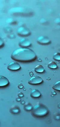 Enhance your phone's aesthetic appeal with this stunning live wallpaper featuring a macro photograph of water droplets on a surface