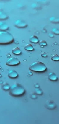This phone live wallpaper showcases a visually stunning and calming scene of water droplets