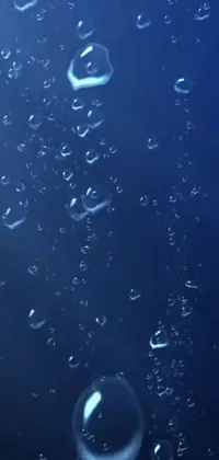This phone live wallpaper features a serene deep-sea ambiance, with bubbles floating on a blue surface