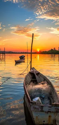 This live wallpaper features a stunning shutterstock image of a boat gently sitting in the water against a vibrant sunrise