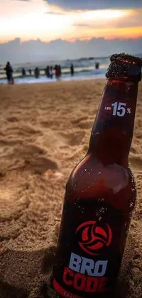 This live wallpaper features a refreshing beer bottle resting on a picturesque sandy beach