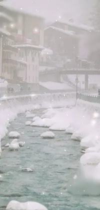 This phone live wallpaper showcases a snowy city in an alpine climate, featuring a river with a distant onsen