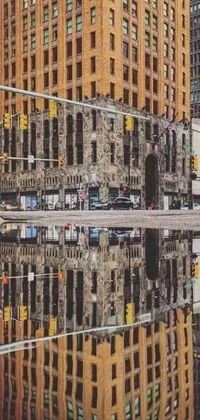 This stunning phone live wallpaper features a photorealistic reflection of towering buildings in a puddle of water at an intersection in Michigan