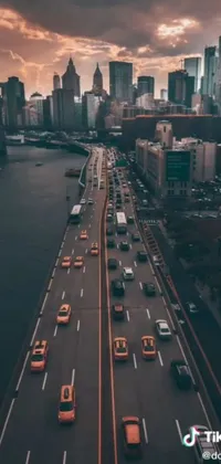 This live phone wallpaper depicts a busy city situated by a flowing river