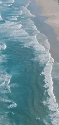 Looking for a serene and tranquil live wallpaper for your phone? Look no further than this stunning phone live wallpaper! This wallpaper depicts a beautiful body of water next to a sandy beach, with soaring waves crashing against the shore