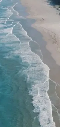 Looking for a stunning live wallpaper for your phone? Look no further than this amazing scene of a large body of water next to a sandy beach! With a stunning fine-art aesthetic and a close-up view of the South African coastline, this wallpaper is sure to capture your imagination and immerse you in the beauty of the ocean