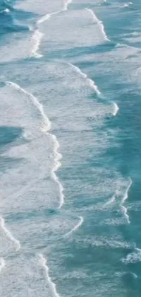 This live wallpaper for your phone features a breathtaking image of a surfer riding a wave-covered beach