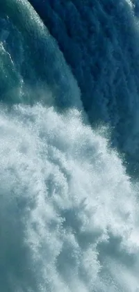 Experience the thrill and excitement of surfing with this stunning live wallpaper! The vivid scene showcases a surfer riding a wave on his board, while the background highlights the natural wonder of Niagara Falls through a close-up view of the magic water gate