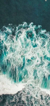 This live wallpaper features a detailed painting of people surfing on top of a wave from a bird's eye view