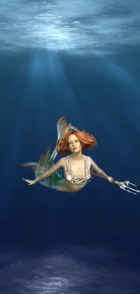 Make a splash with this stunning live wallpaper for your phone! Dive into the depths of the ocean with the elegant mermaid, who is surrounded by a variety of colorful sea creatures