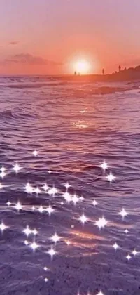 This phone live wallpaper showcases a serene ocean sunset with stars illuminating the sky
