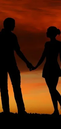 This live wallpaper features a stunning silhouette of a man and woman hand-in-hand against a beautiful late summer evening backdrop
