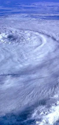 Looking for a captivating live wallpaper for your phone? Check out this detailed zoom photo taken from the international space station in 1997! Enclosed in a circle and round-cropped with a black background, this stunning image depicts a hurricane from outer space