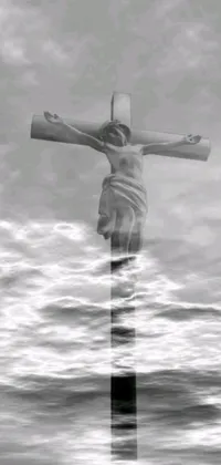 Looking for a beautifully haunting wallpaper for your phone screen? Check out this black and white photograph of a person on a cross, featuring an ambient occlusion render and airbrushed clouds