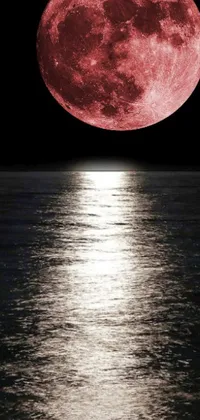This phone live wallpaper showcases a breathtaking digital rendering of a full moon over a calm body of water