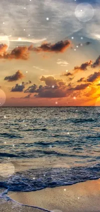 This phone live wallpaper features a stunning sunset over the ocean on a beach, captured in 4K UHD resolution