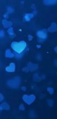 Make your phone screen come alive with the Blue Hearts Live Wallpaper! This mesmerizing wallpaper features countless blue hearts floating among a lovely bokeh effect, creating the perfect background for your device