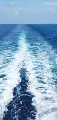 This phone live wallpaper depicts a scenic view of the ocean seen from the back of a ship, which creates beautiful swirly ripples on the water