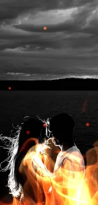 This captivating live wallpaper features a black and white image of a man and woman, dressed in formal attire, standing on the shore of a calm body of water