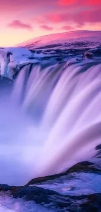 Bring a touch of natural splendor to your phone with this stunning live wallpaper featuring a majestic waterfall in the middle of a vast body of water
