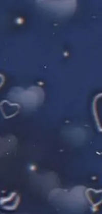 Floating heart-shaped bubbles on a dark blue background make this phone live wallpaper truly enchanting