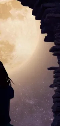 This live wallpaper showcases a woman standing in front of a yellowish full moon, with an animated still screencap that creates a peaceful and mysterious feeling