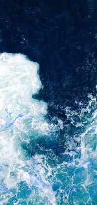This phone live wallpaper exhibits a captivating surfer riding a wave accompanied by blue paint inspired generative art