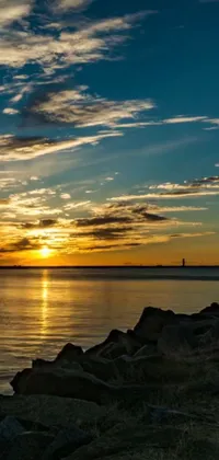Enjoy breathtaking scenery with this sunset live wallpaper! As the sun sets over a tranquil body of water, you'll be welcomed by a lighthouse and a peaceful harbor