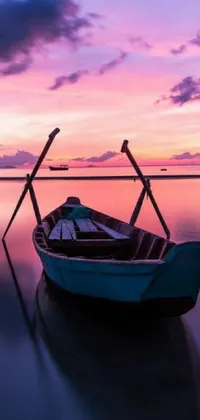 Get lost in the beauty of a small boat floating on top of a body of water with this enchanting phone live wallpaper