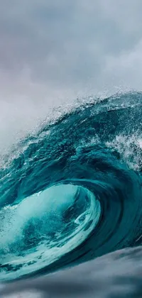 This ocean-themed phone live wallpaper features a surreal image of a person surfing a gigantic wave, captured in stunning detail