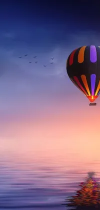 This gorgeous phone live wallpaper features a stunning hot air balloon drifting gracefully across a serene body of water