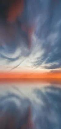 Indulge in the stunning phone live wallpaper featuring a wide water body under a cloudy sky